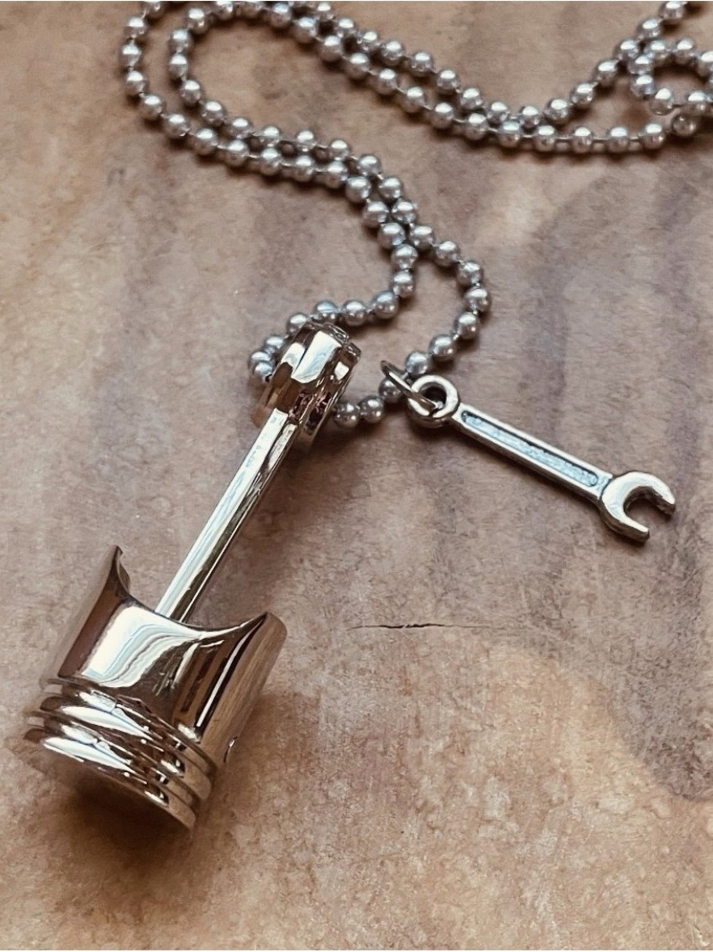Silver piston necklace or keychain with wrench charm